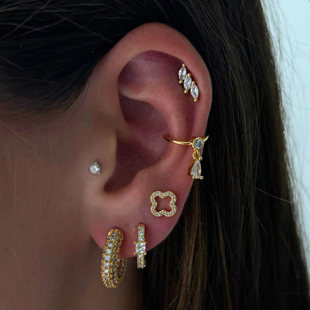 a close up of a person wearing ear piercings